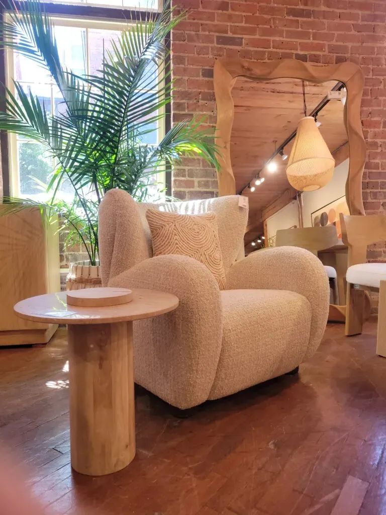 Side table, chair and mirror in a furniture showroom